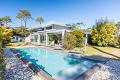 Walk to the beach in this contemporary villa with heated pool
