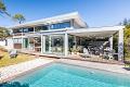 Walk to the beach in this contemporary villa with heated pool